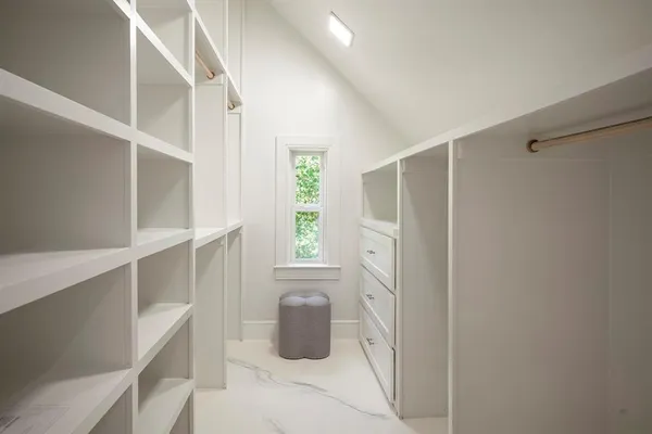 a balcony view with a large window and outdoor seating