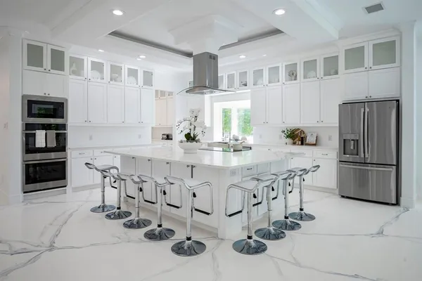 a kitchen with stainless steel appliances a sink and a refrigerator