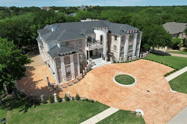 an aerial view of residential house with outdoor space and trees all around