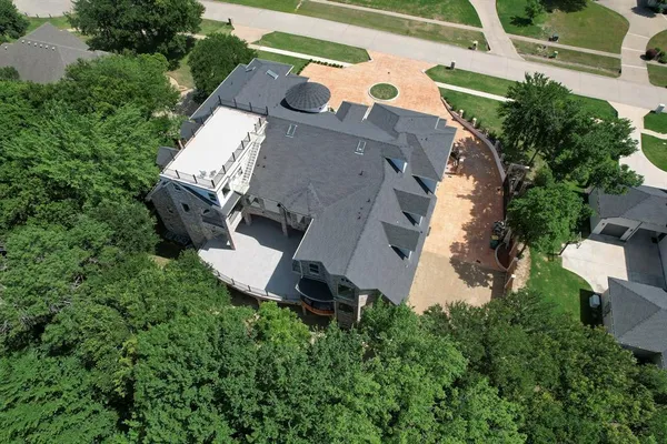 an aerial view of a house with a yard