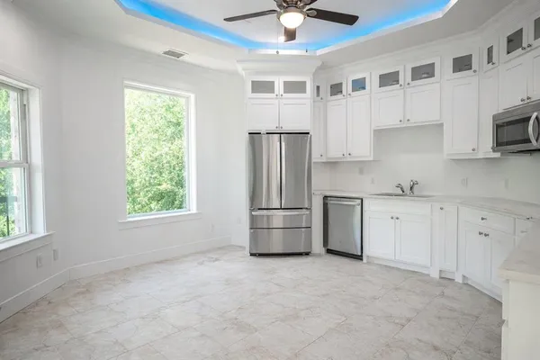 a kitchen with stainless steel appliances a refrigerator sink and cabinets