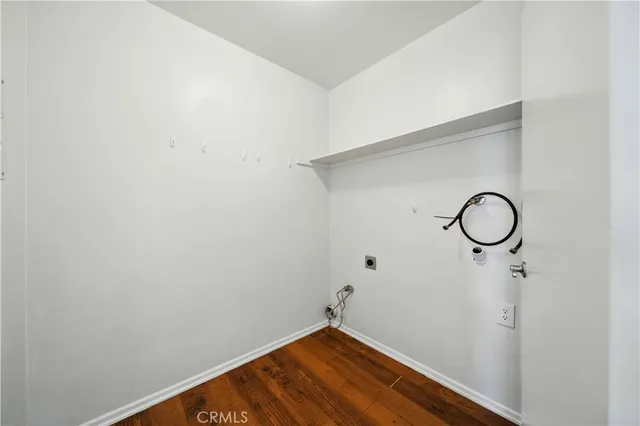 a view of a room with wooden floor and white walls
