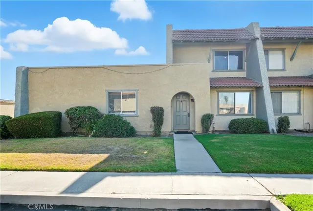 a front view of a house with garden