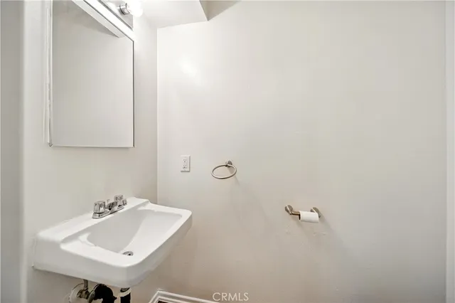 a bathroom with a sink and mirror
