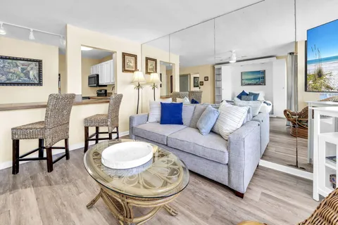 a living room with furniture a dining table and a fireplace