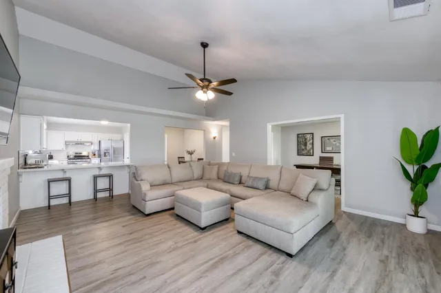 a living room with furniture and a wooden floor