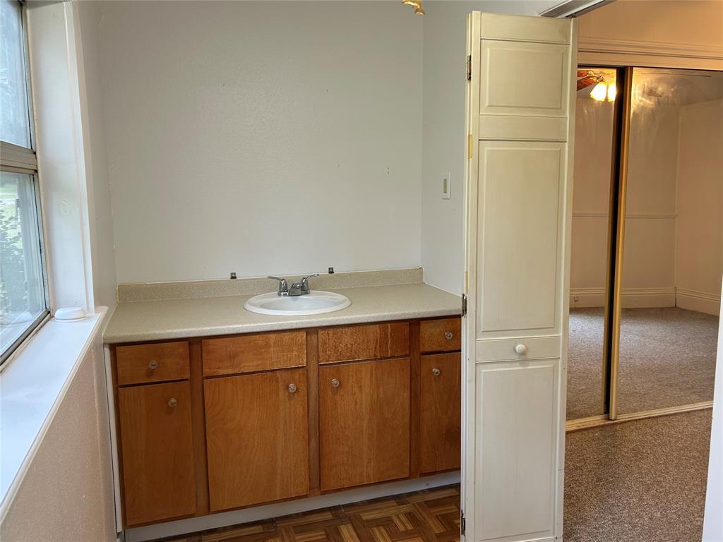 302 North Commerce Savoy, TX 75479 - Photo 12 of 32 a bathroom with a sink and a mirror