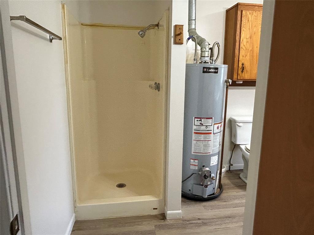 302 North Commerce Savoy, TX 75479 - Photo 15 of 32 a bathroom with a shower