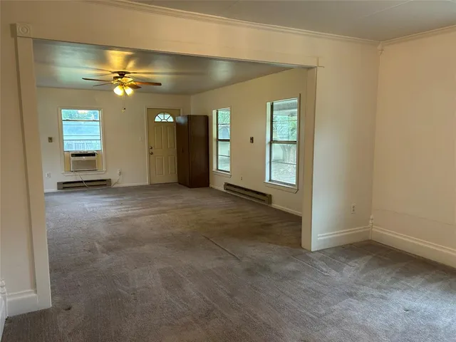 an empty room with closet and a chandelier fan