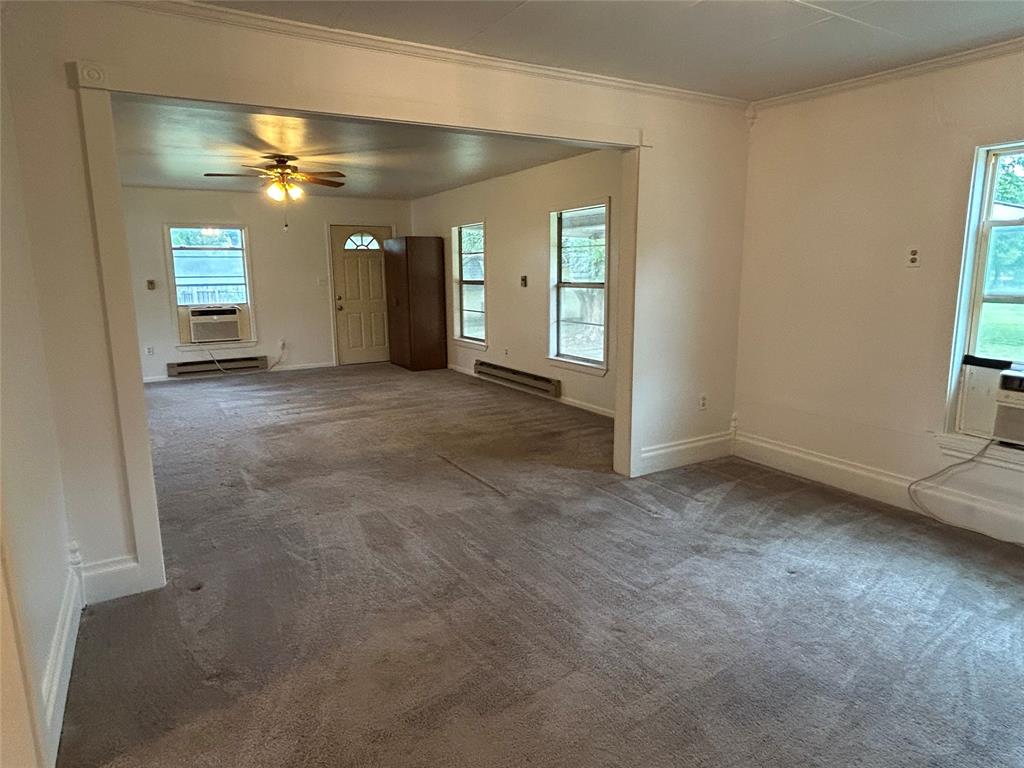 302 North Commerce Savoy, TX 75479 - Photo 25 of 32 an empty room with windows and closet