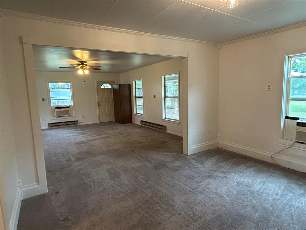 302 North Commerce Savoy, TX 75479 - Photo 6 of 32 an empty room with windows and fan