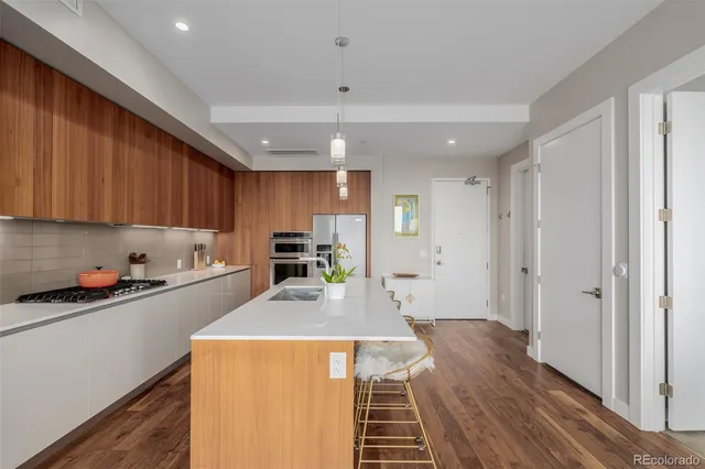 a kitchen with sink cabinets and wooden floor
