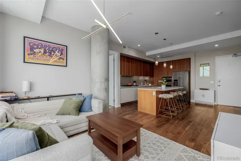 a living room with furniture and kitchen view