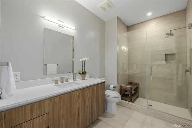 a bathroom with a double vanity sink mirror and shower
