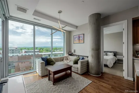 a living room with furniture and a floor to ceiling window