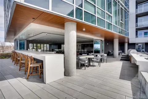 a view of a patio with dining table and chairs