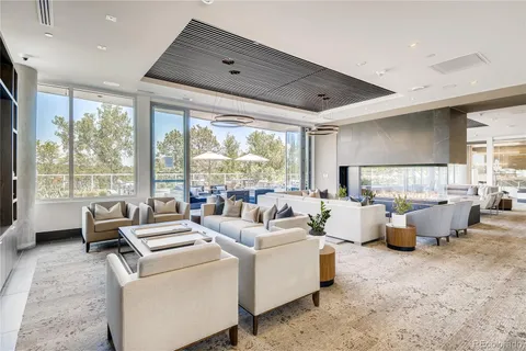 a living room with furniture and large windows