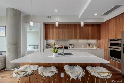 a kitchen with a dining table chairs and refrigerator