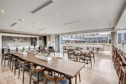 a view of a dining room and livingroom with lots of furniture and white walls