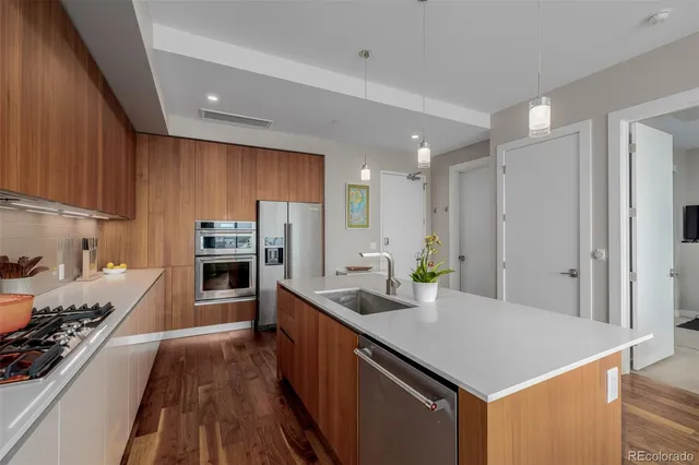 a kitchen with stainless steel appliances sink stove microwave and cabinets