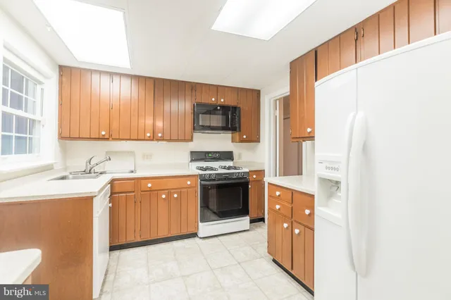 a kitchen with stainless steel appliances granite countertop a stove and a sink