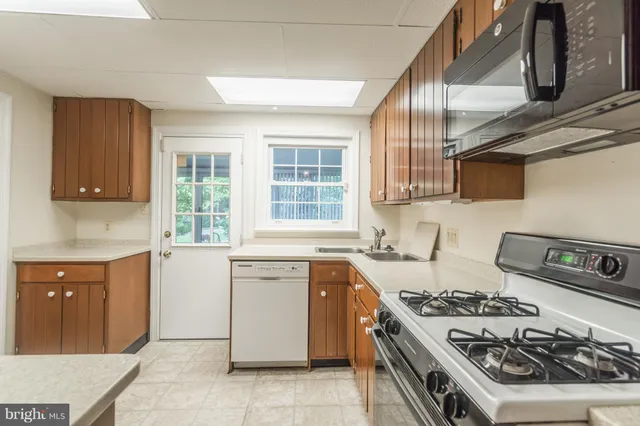 a kitchen with a stove a sink and a microwave