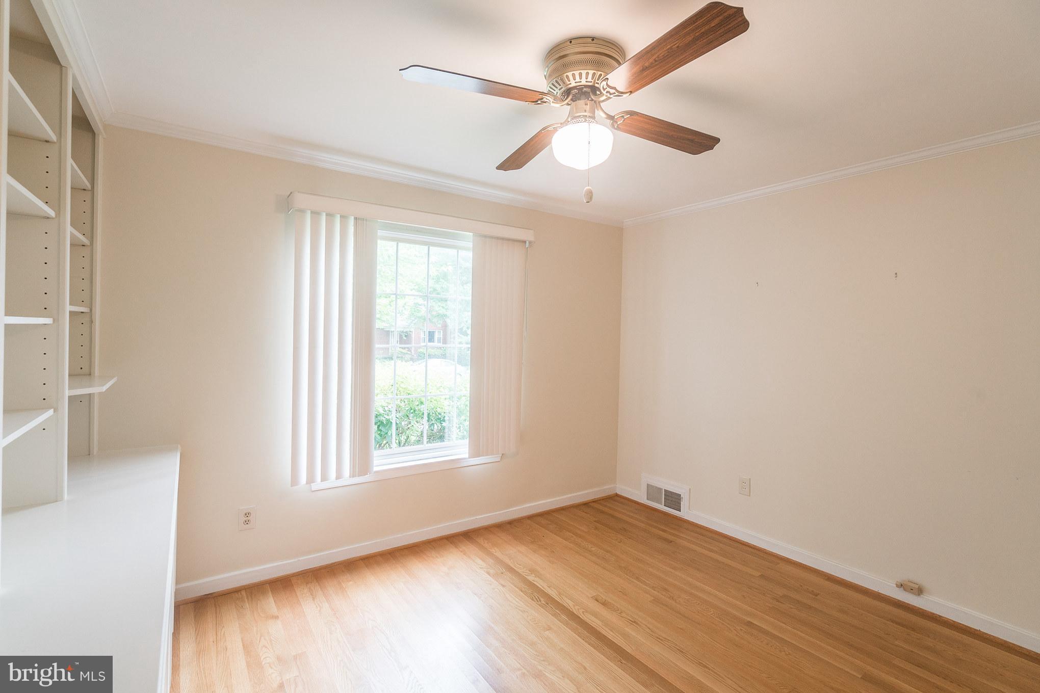 6104 28th Street North Arlington, VA 22207 - Photo 18 of 30 an empty room with wooden floor fan and windows