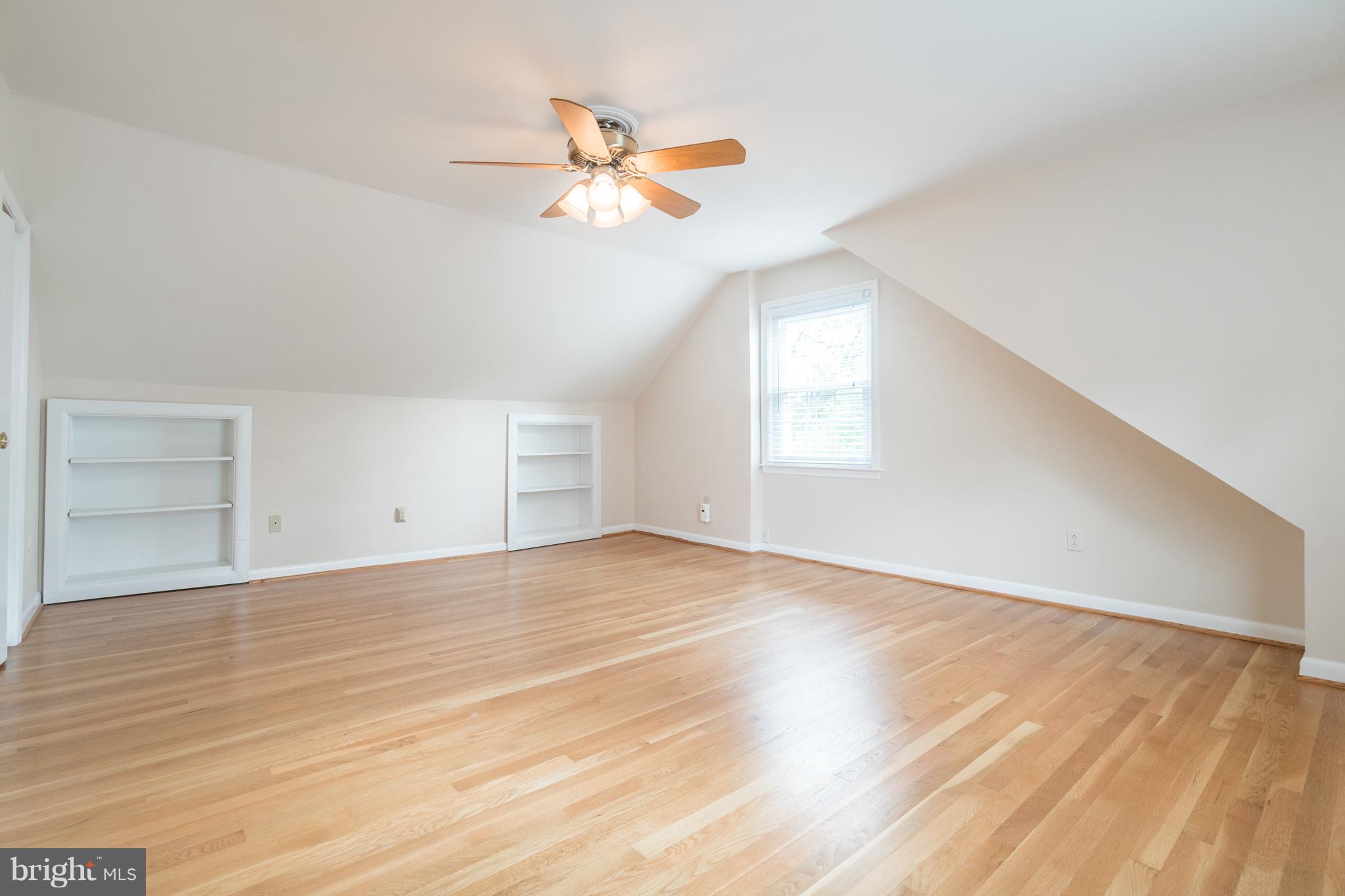6104 28th Street North Arlington, VA 22207 - Photo 20 of 30 an empty room with wooden floor fan and windows