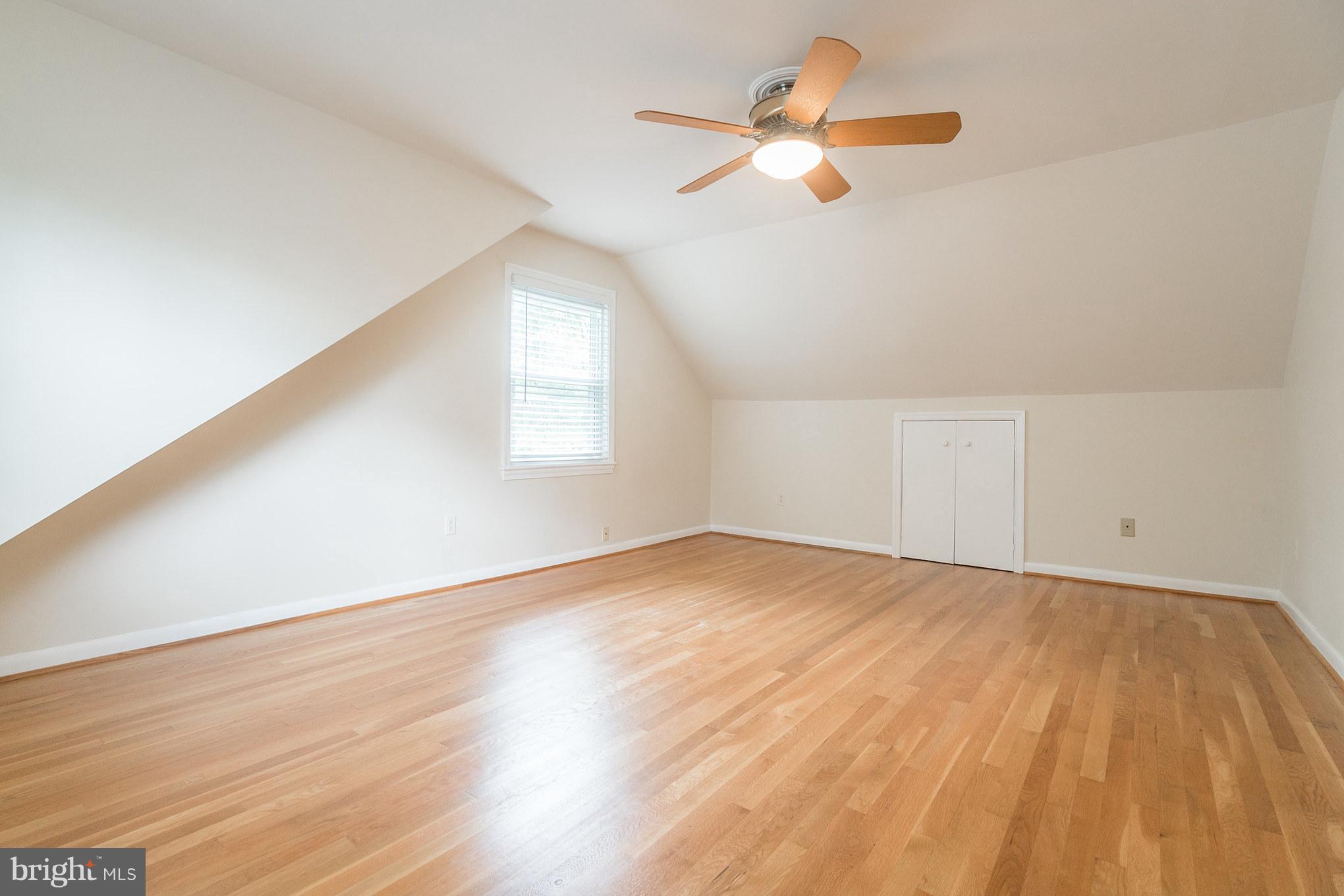 6104 28th Street North Arlington, VA 22207 - Photo 24 of 30 an empty room with wooden floor fan and windows
