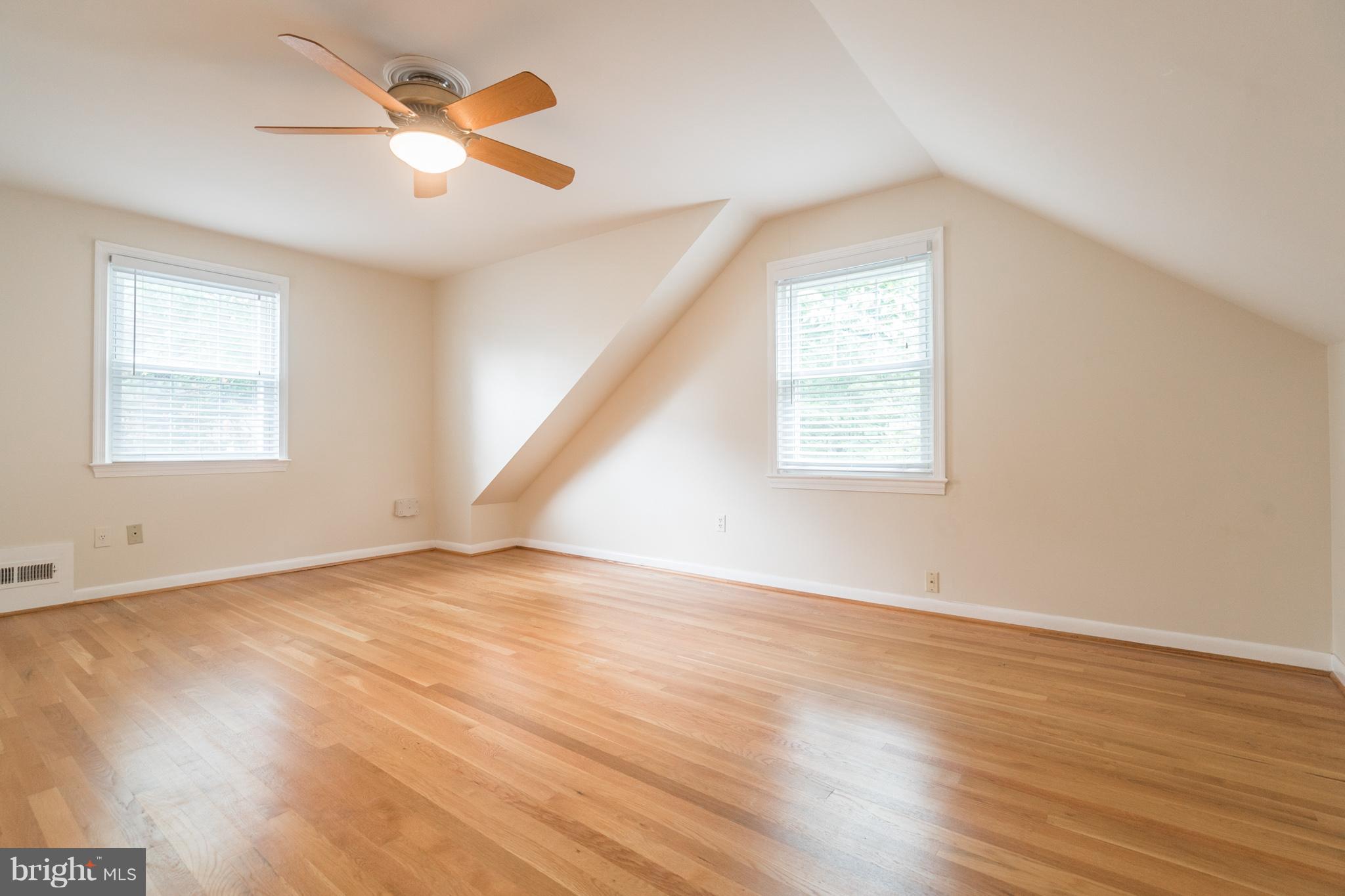 6104 28th Street North Arlington, VA 22207 - Photo 25 of 30 an empty room with wooden floor fan and windows