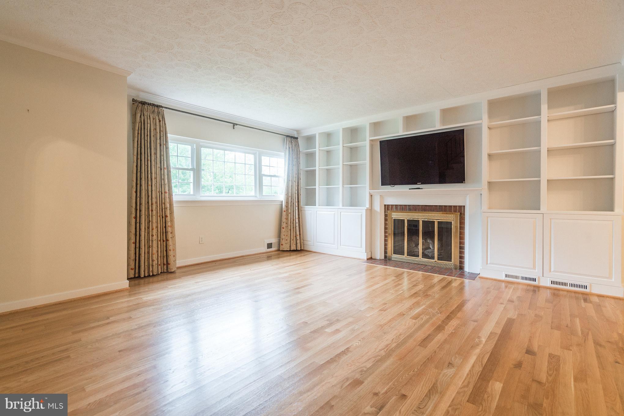 6104 28th Street North Arlington, VA 22207 - Photo 5 of 30 a view of a livingroom with furniture a flat screen tv and wooden floor
