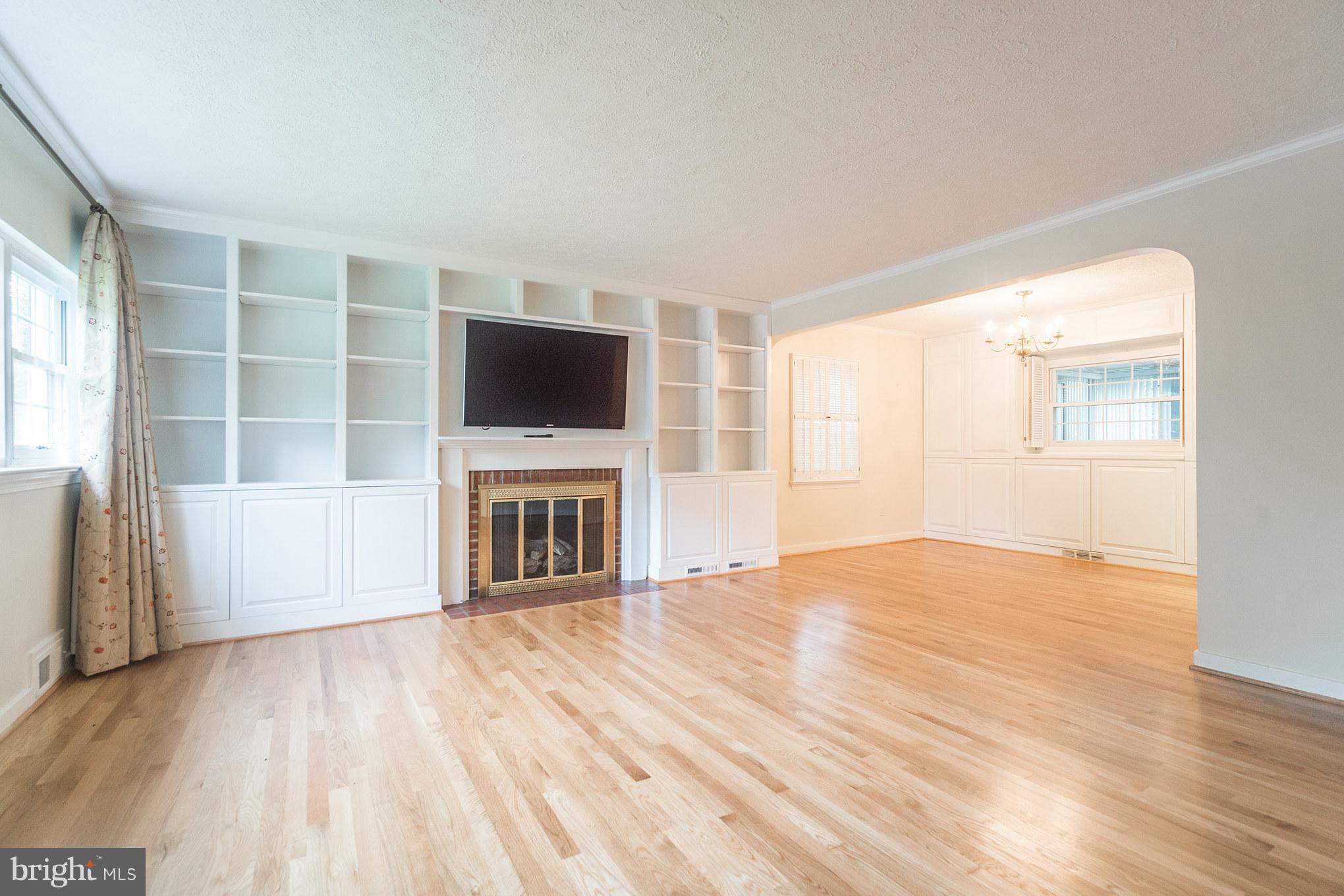 6104 28th Street North Arlington, VA 22207 - Photo 6 of 30 a view of a livingroom with a fireplace wooden floor and window