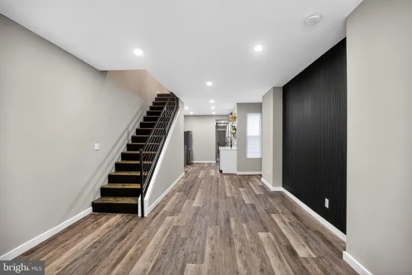 a view of hallway with wooden floor