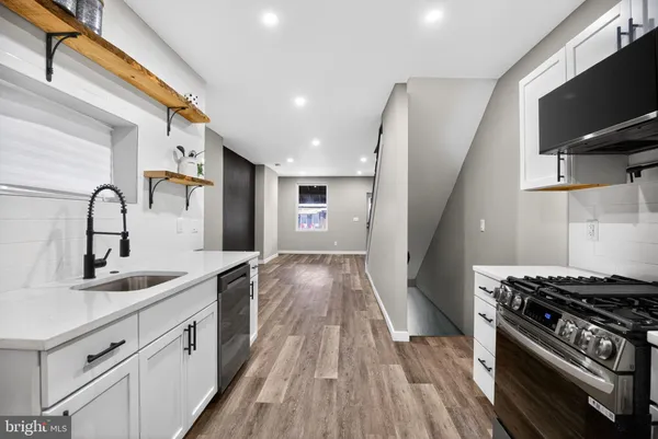 a kitchen with a sink cabinets and appliances