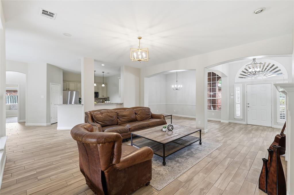 2402 Ravinia Drive Corinth, TX 76208 - Photo 14 of 40 The property features an open living space that easily flows from kitchen to living to dining.