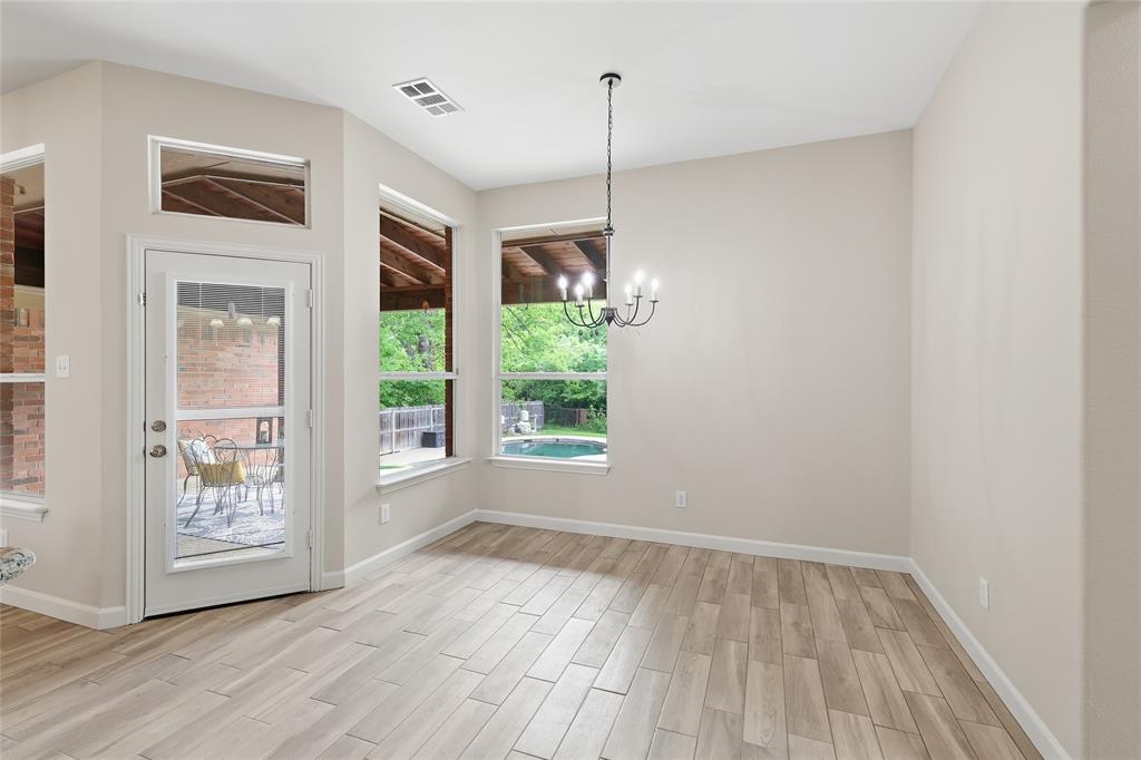 2402 Ravinia Drive Corinth, TX 76208 - Photo 19 of 40 Dining area with access to the covered patio and large windows with views of the backyard and pool