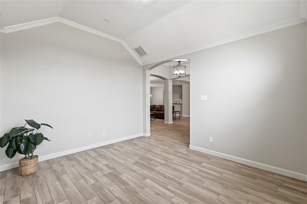 2402 Ravinia Drive Corinth, TX 76208 - Photo 9 of 40 This inviting interior space features light-toned plank flooring and crisp white baseboards
