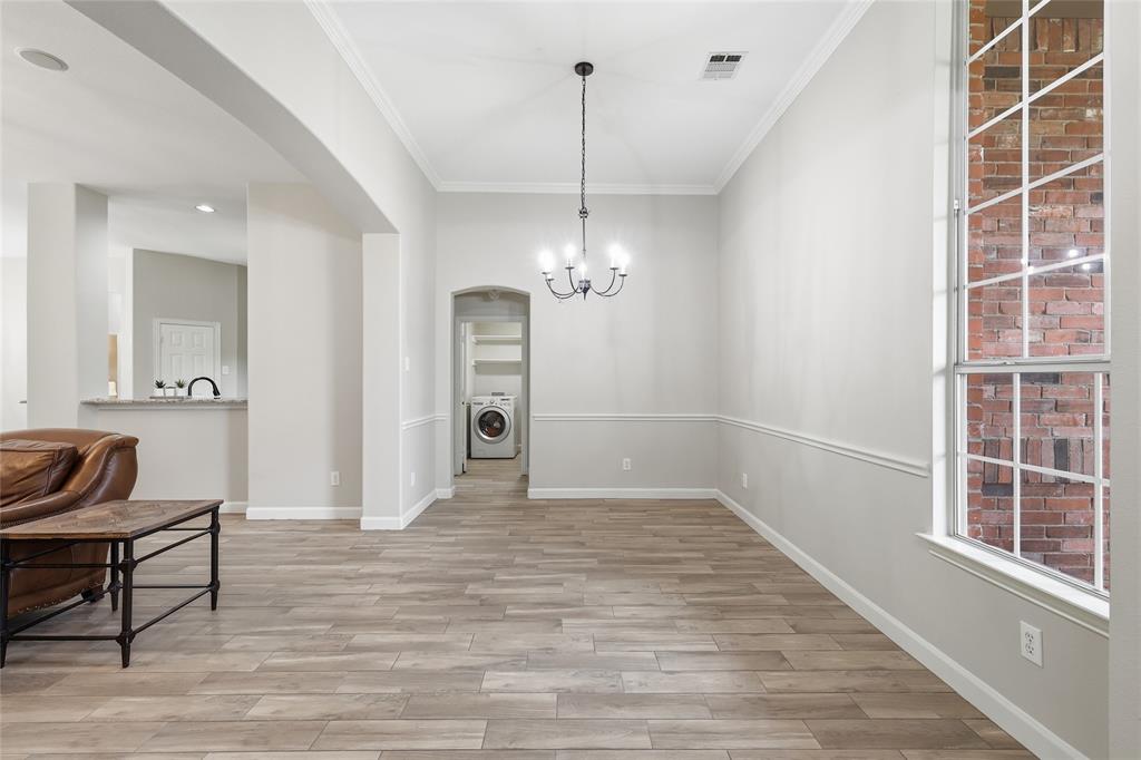2402 Ravinia Drive Corinth, TX 76208 - Photo 10 of 40 Spacious room with wood-style flooring, crown molding, and wainscoting