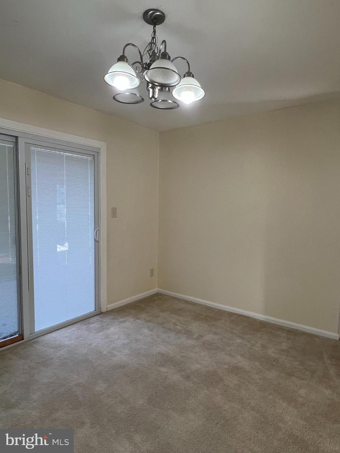 1005 Arcola Avenue Silver Spring, MD 20902 - Photo 8 of 28 a view of an empty room with a chandelier fan