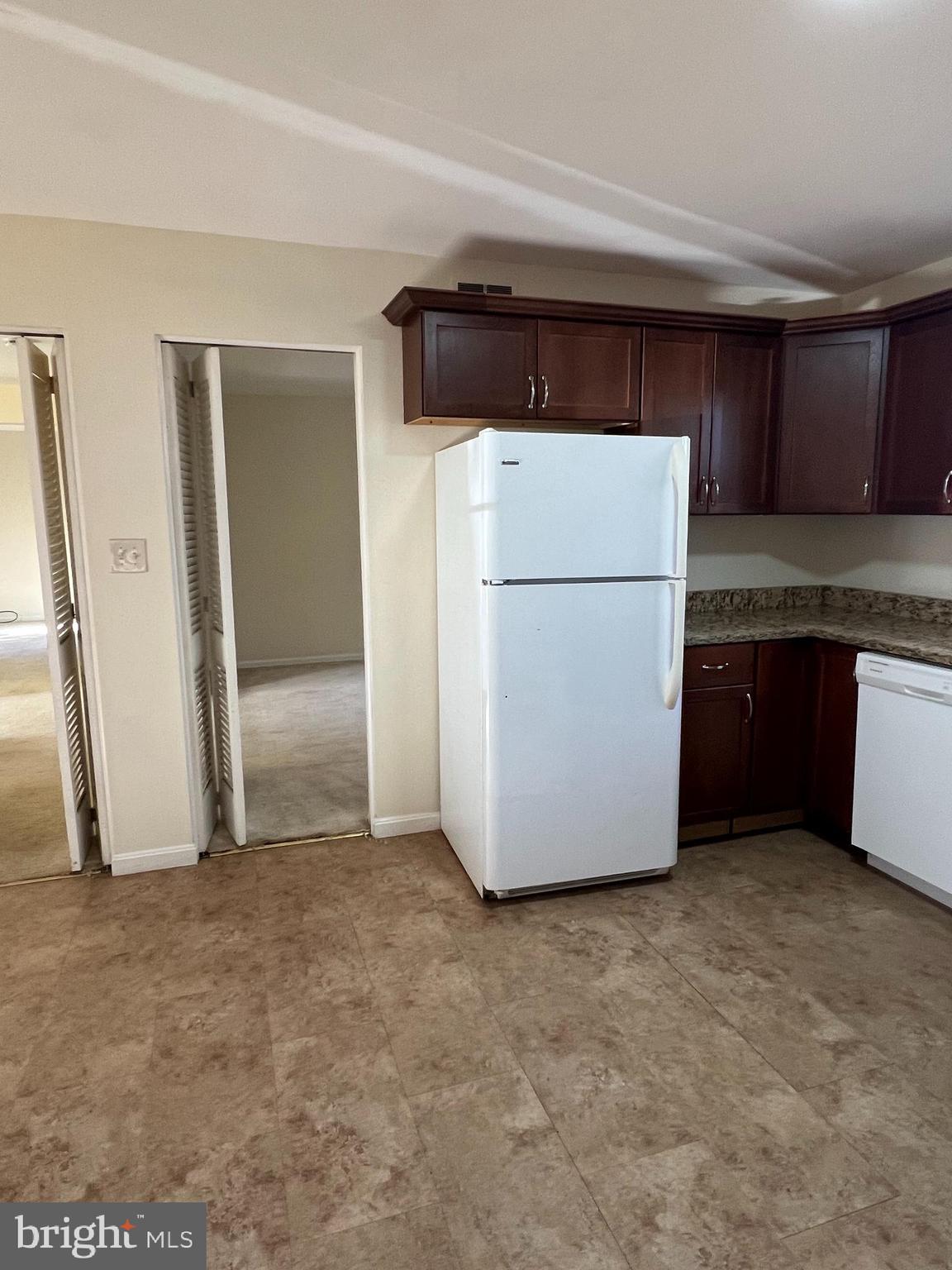 1005 Arcola Avenue Silver Spring, MD 20902 - Photo 9 of 28 a view of kitchen with refrigerator and white cabinets