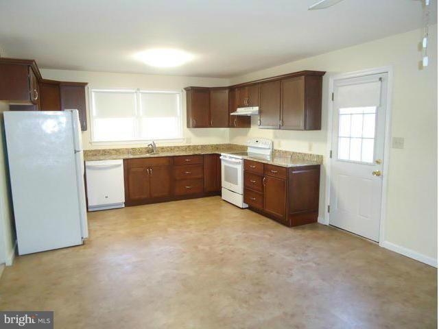 1005 Arcola Avenue Silver Spring, MD 20902 - Photo 10 of 28 a large kitchen with cabinets and stainless steel appliances