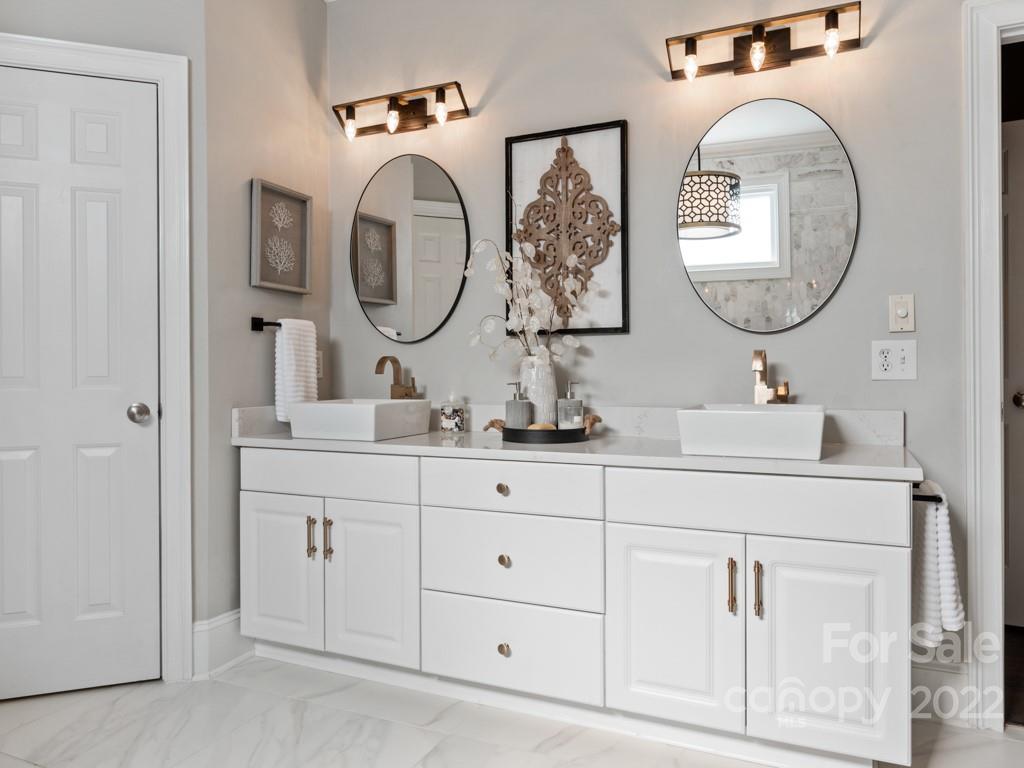 5015 Rea Road Charlotte, NC 28226 - Photo 17 of 48 a bathroom with a double vanity sink and a mirror