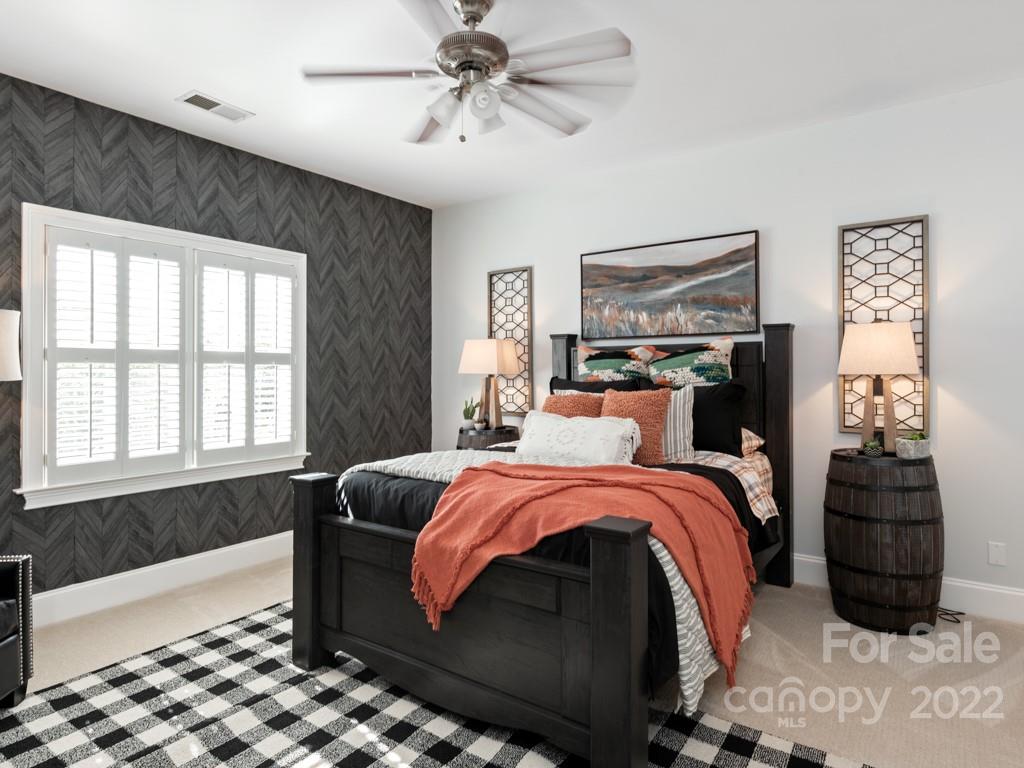 5015 Rea Road Charlotte, NC 28226 - Photo 20 of 48 a bedroom with a bed and wooden floor