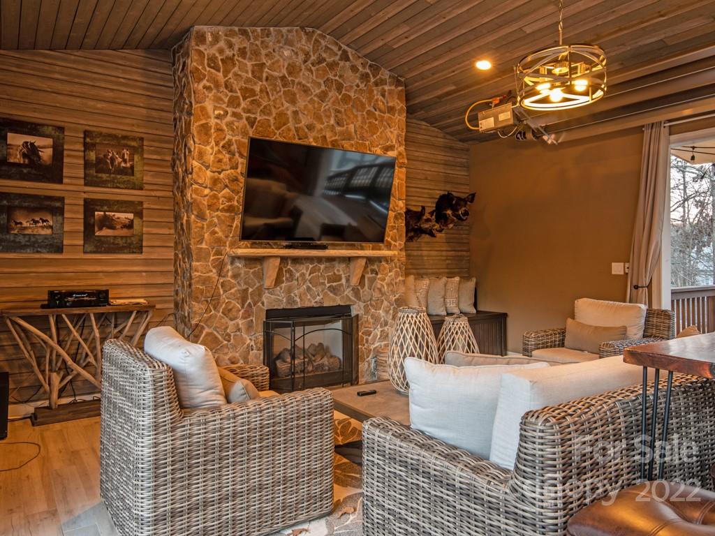 5015 Rea Road Charlotte, NC 28226 - Photo 40 of 48 a living room with furniture a flat screen tv and a fireplace