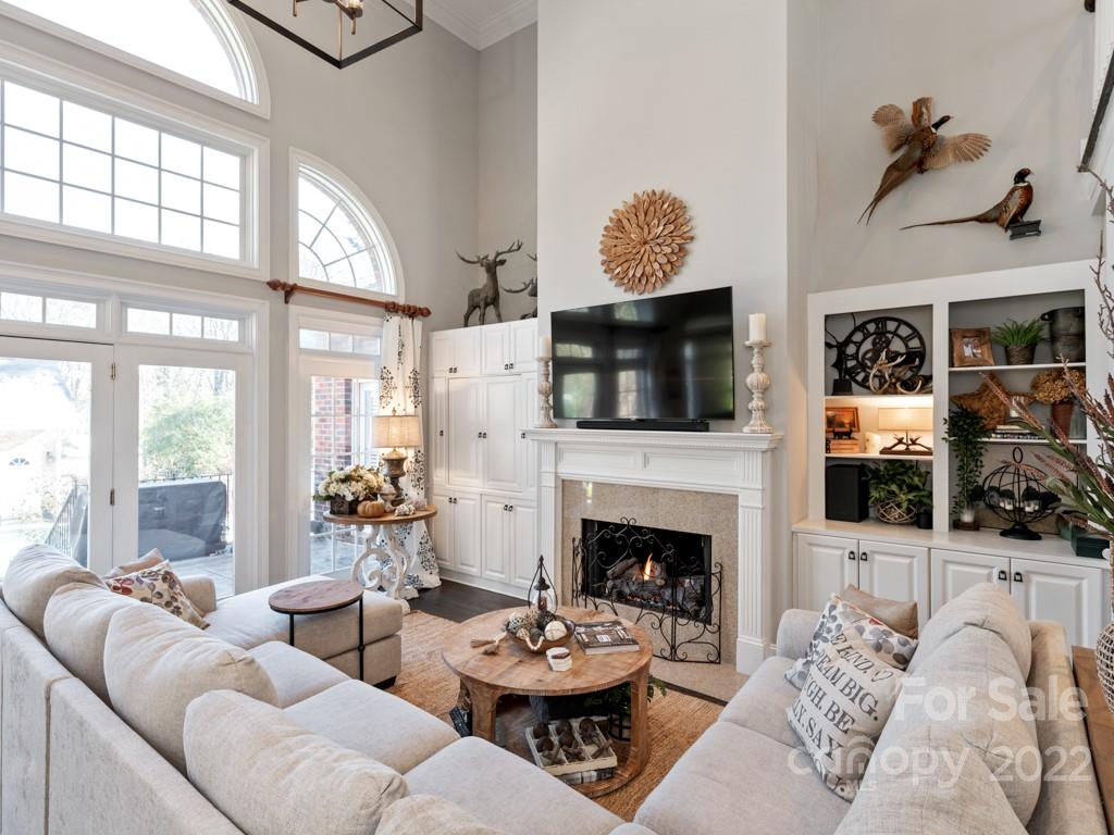 5015 Rea Road Charlotte, NC 28226 - Photo 6 of 48 a living room with furniture a fireplace and a flat screen tv