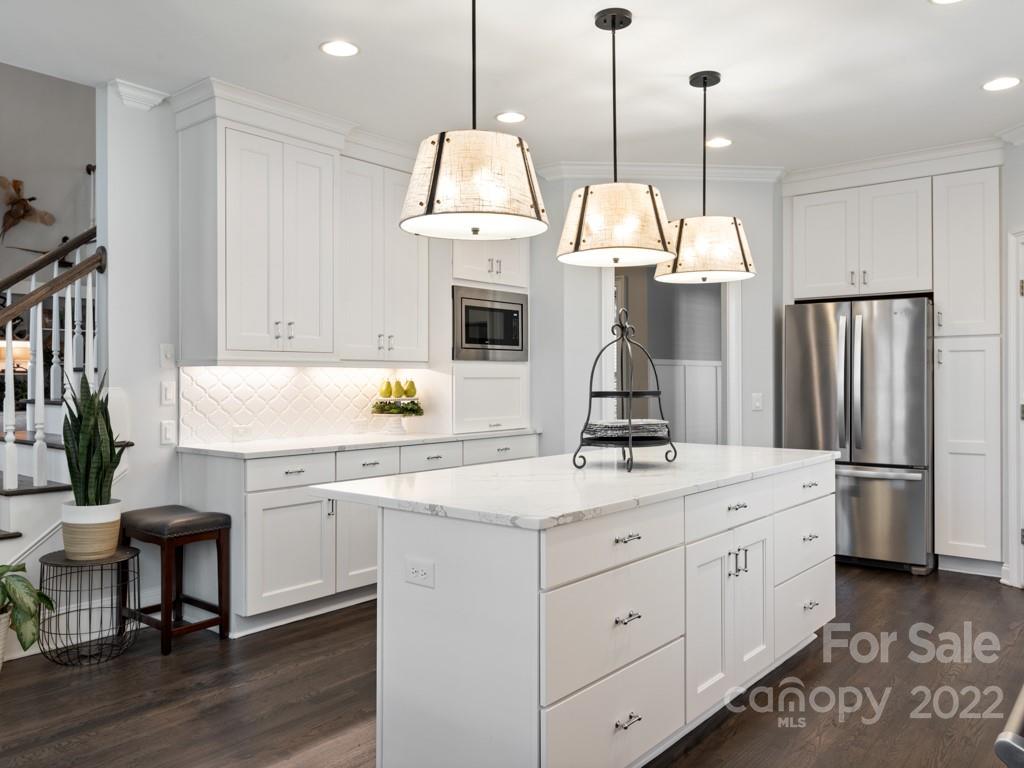 5015 Rea Road Charlotte, NC 28226 - Photo 9 of 48 a kitchen with a sink stainless steel appliances and wooden floor