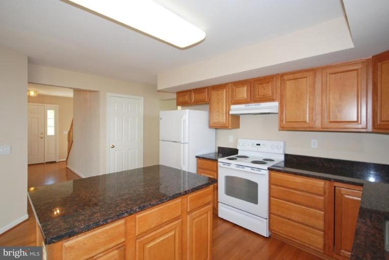 5976 Florey Road Hanover, MD 21076 - Photo 30 of 30 a kitchen with stainless steel appliances granite countertop a stove a sink and a refrigerator