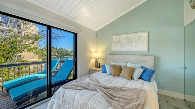 a bed sitting in a bedroom next to a large window