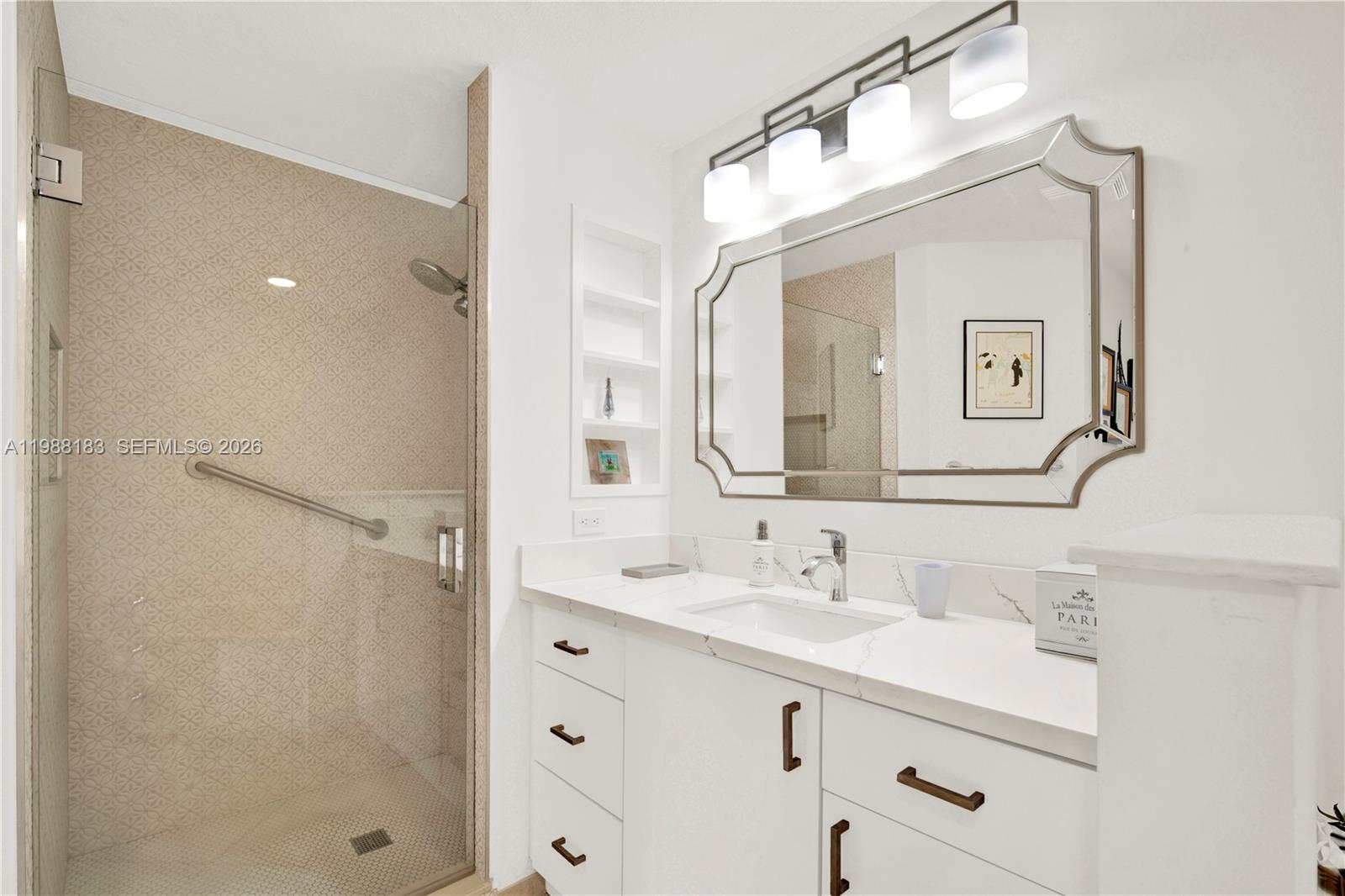 9021 Southwest 94th Street, Unit 308 Miami, FL 33176 - Photo 16 of 35 a bathroom with a double vanity sink mirror and shower