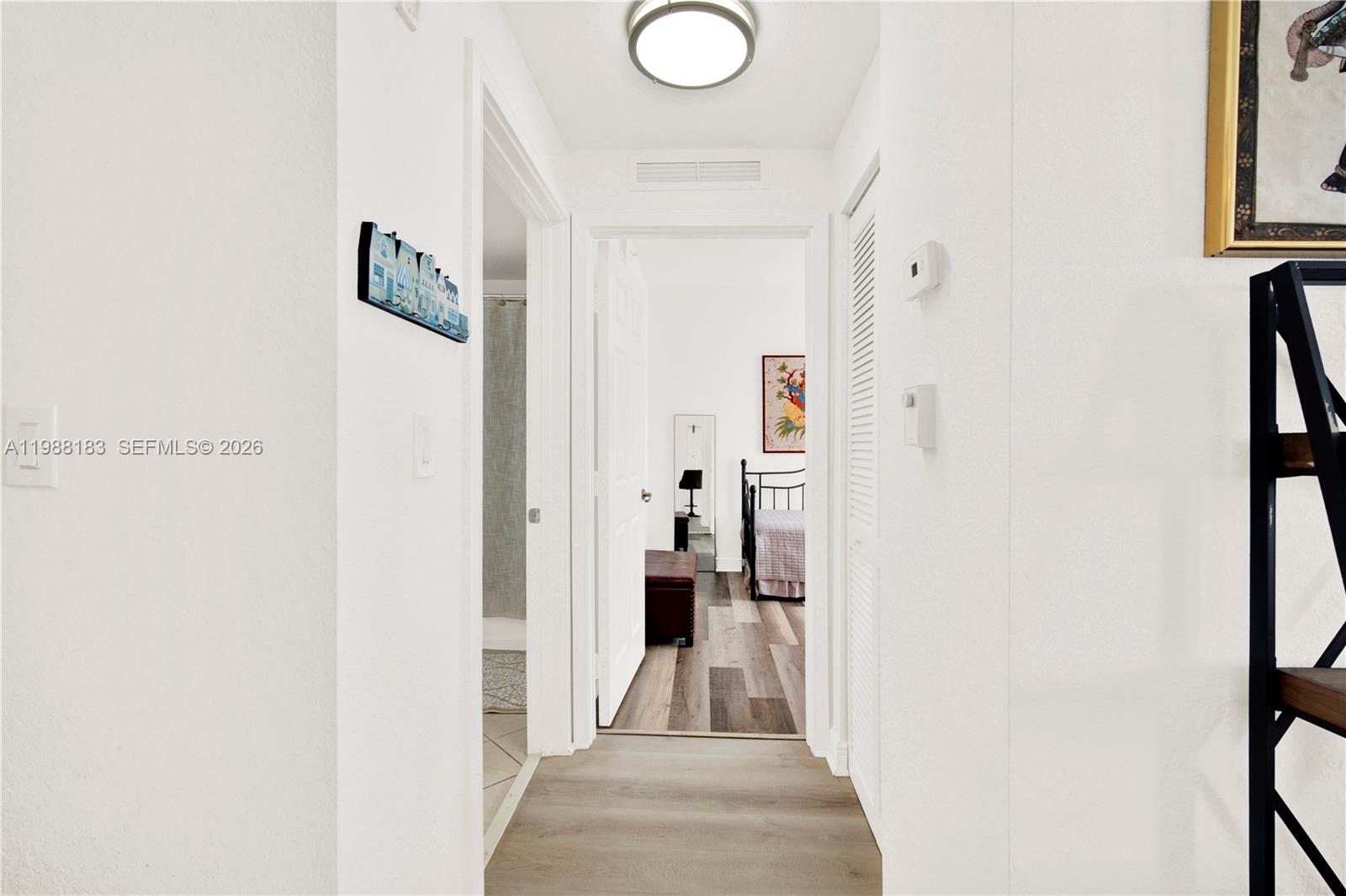 9021 Southwest 94th Street, Unit 308 Miami, FL 33176 - Photo 18 of 35 a view of a hallway with paintings on the wall